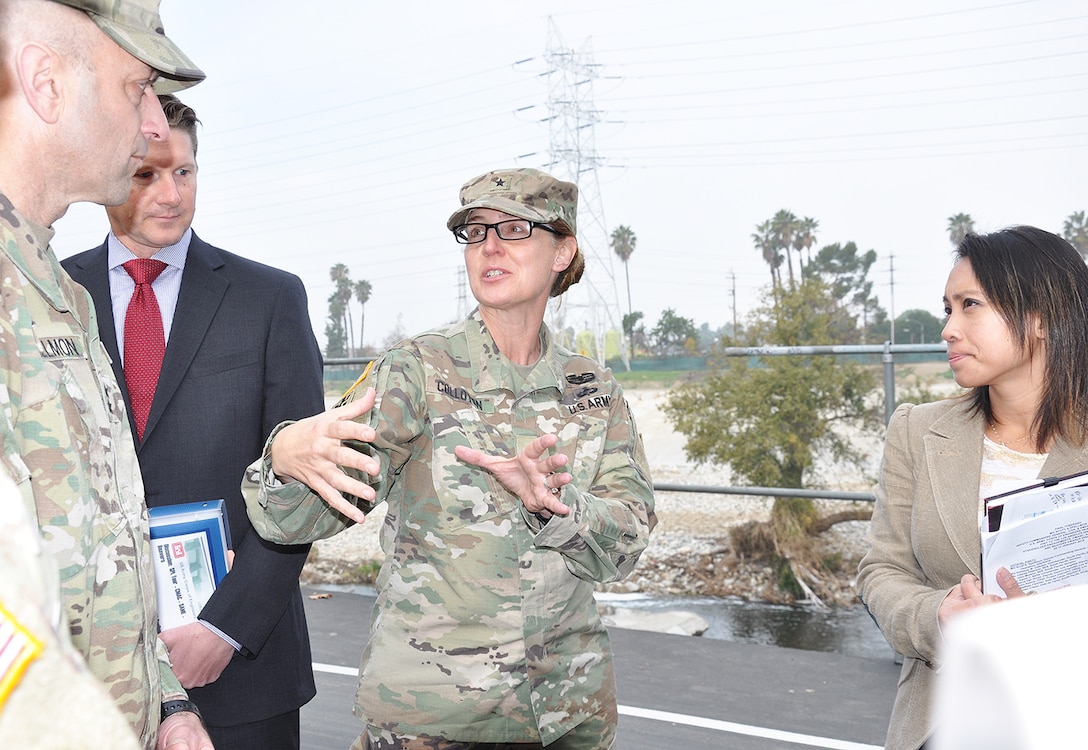 Brig. Gen. Kim Colloton, U.S. Army Corps of Engineers South Pacific Division commander, center, speaks about the LA River during a project tour for Maj. Gen. Scott Spellmon, U.S. Army Corps of Engineers deputy commanding general for Civil and Emergency Operations, left, Jan. 11 in Los Angeles, while David Van Dorpe, LA District deputy engineer and chief of the Programs and Project Management Division, and Lillian Doherty, LA District chief of the Operations Branch, look on.