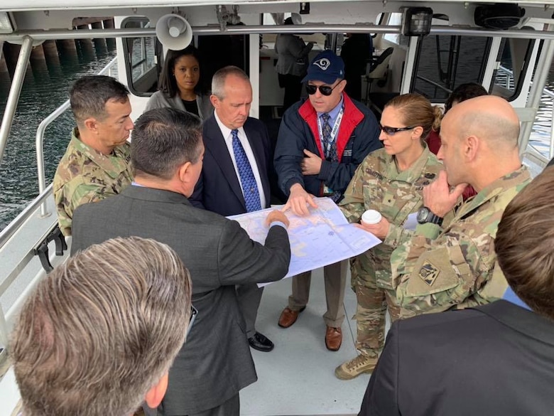 Maj. Gen. Scott Spellmon, U.S. Army Corps of Engineers deputy commanding general for Civil and Emergency Operations, second from right; Brig. Gen. Kim Colloton, South Pacific Division commander, third from right; and Col. Aaron Barta, LA District commander, third from left, receive a briefing about the ports of Los Angeles and Long Beach during a Jan. 10 boat tour around the ports.