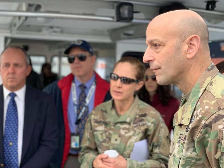 Maj. Gen. Scott Spellmon, U.S. Army Corps of Engineers deputy commanding general for Civil and Emergency Operations, right, and Brig. Gen. Kim Colloton, South Pacific Division commander, second from right, receive a briefing about the ports of Los Angeles and Long Beach during a Jan. 10 boat tour around the ports.