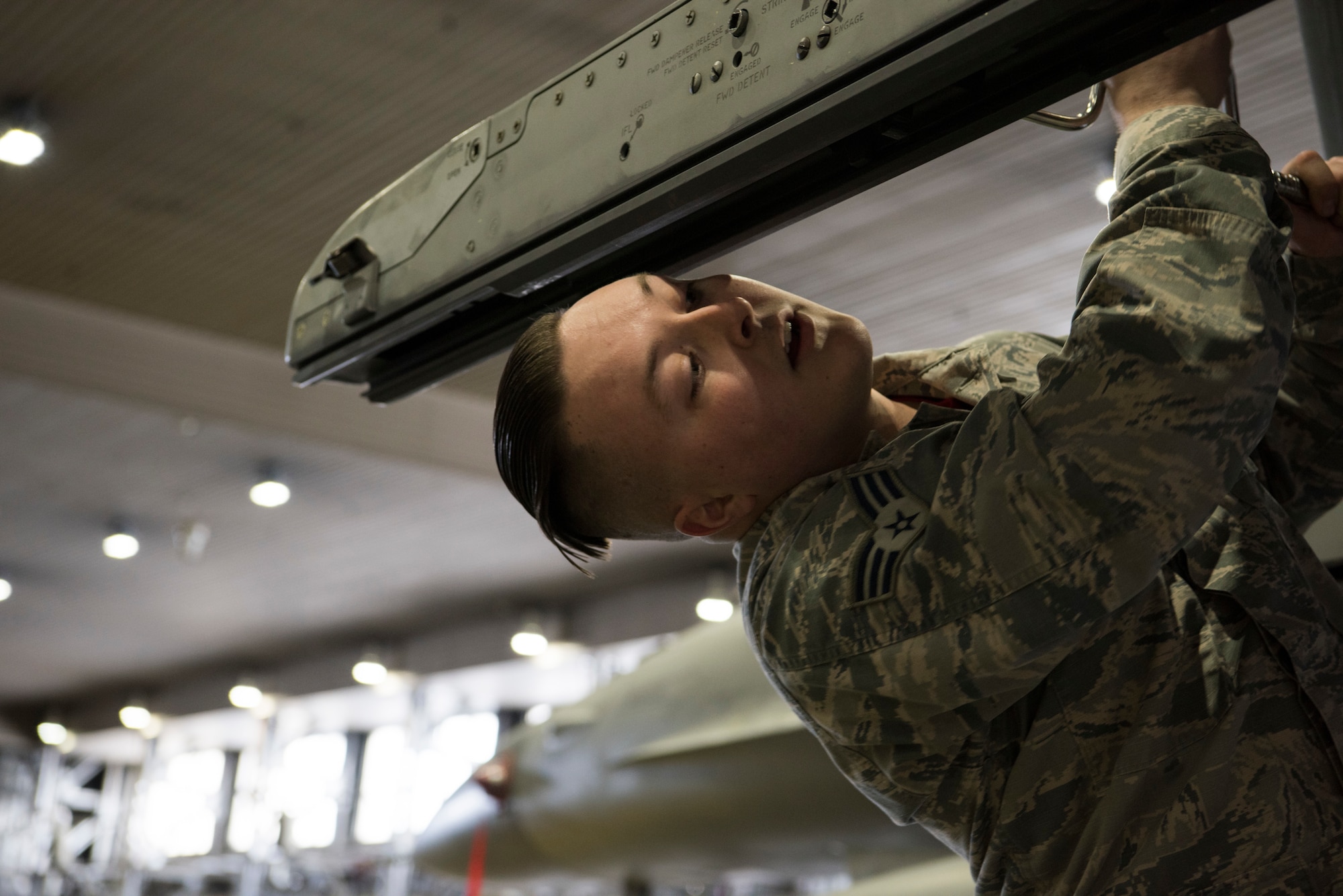 U.S. Air Force Senior Airman Jacob Schoepp, a 13th Aircraft Maintenance Unit weapons load crew member, tightens a bolt on an F-16 Fighting Falcon during the fourth quarter weapons load competition at Misawa Air Base, Japan, Jan. 18, 2019. The competition assessed various Airmen’s abilities to quickly and properly arm an F-16 Fighting Falcon with inert munitions, which can range from two 2,000 lb bombs to two AIM-120s or AIM-9s. (U.S. Air Force photo by Airman 1st Class Collette Brooks)