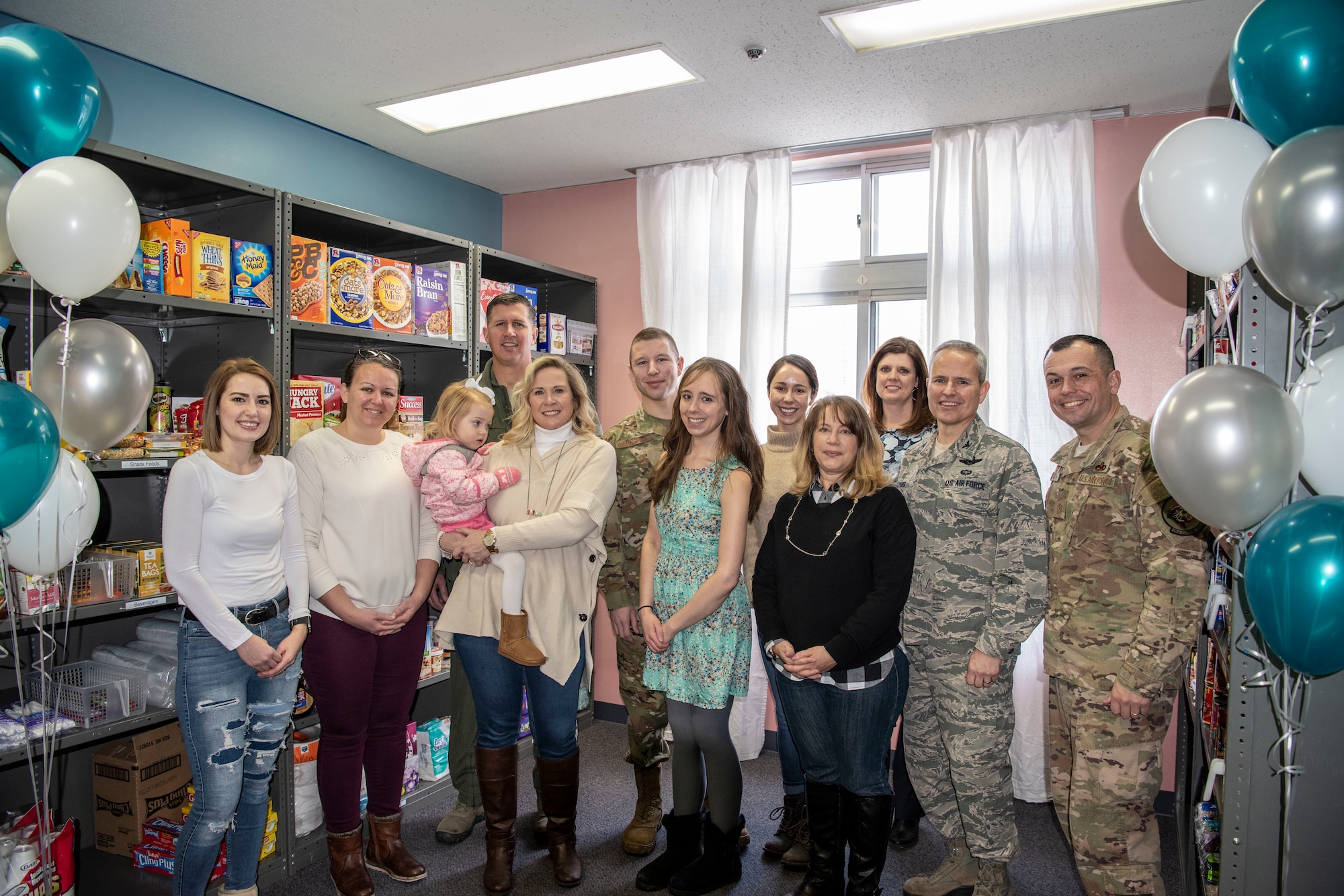 Thrift Shop volunteers and 35th Fighter Wing Misawa Air Base leadership pause for a photo during the Misawa Thrift Shop food pantry opening at MAB, Japan, Jan. 29, 2019. The thrift shop now offers canned good giving Airmen the opportunity to stock up on essential food items when in need. (U.S. Air Force photo by Airman 1st Class Xiomara Martinez)