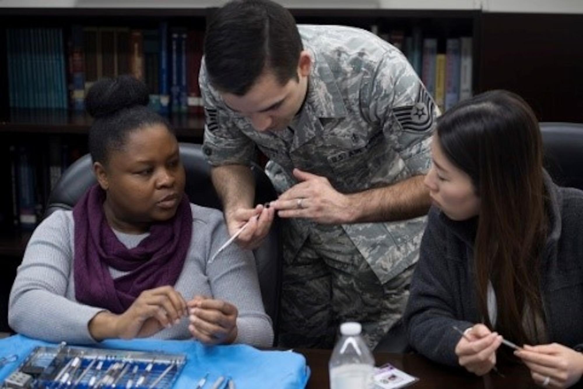 Tech Sgt. Thomas McCarthy, 374th Dental Squadron dental assisting craftsman and volunteer Red Cross Dental Assistant program coordinator, shows volunteers the details of a dental tool during a Red Cross Dental Assistant course, Jan. 9, 2019, at Yokota Air Base, Japan.