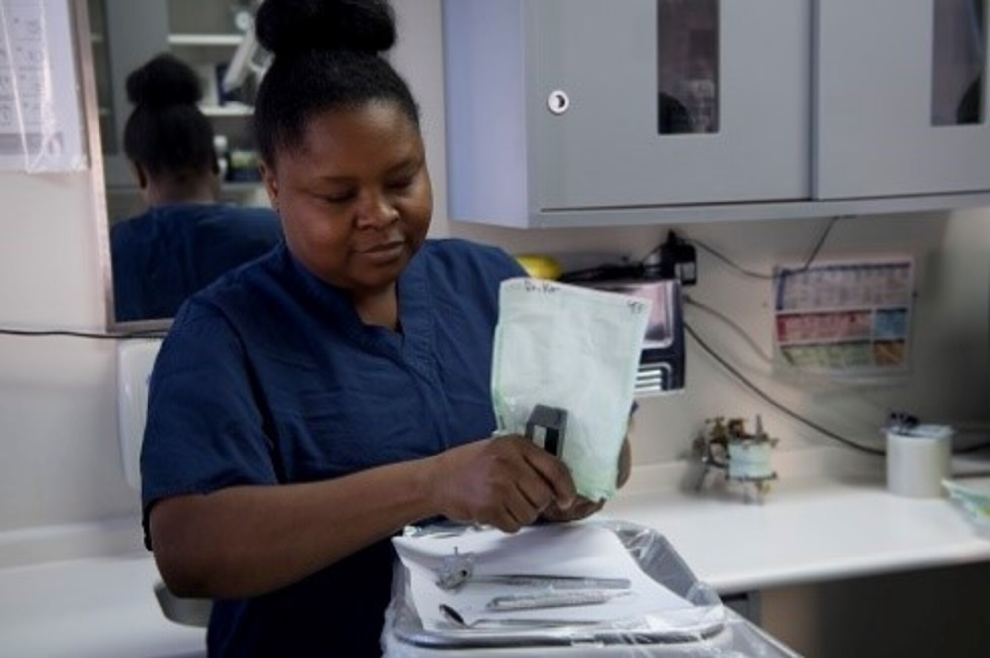Marjorie Chery, Red Cross Dental Assisting volunteer, practices the proper way of opening sterilize instrument packaging during a Red Cross Dental Assistant class, Jan. 11, 2019, at Yokota Air Base, Japan.