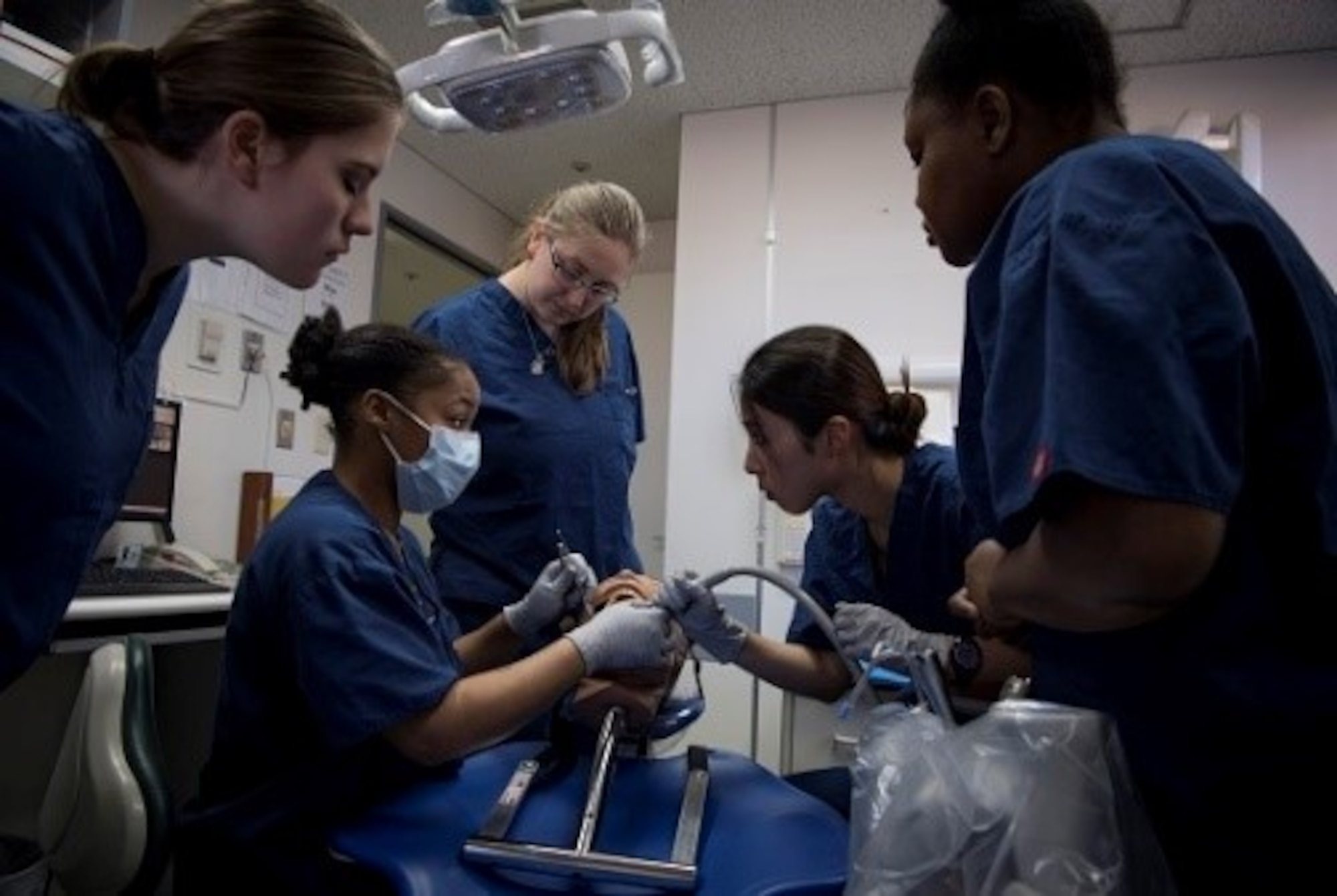 Senior Airman Johnetta Jones, 374th Dental Squadron dental assistant, shows volunteers how to properly apply suction on a mock patient during a Red Cross Dental Assistant course, Jan. 11, 2019, at Yokota Air Base, Japan.
