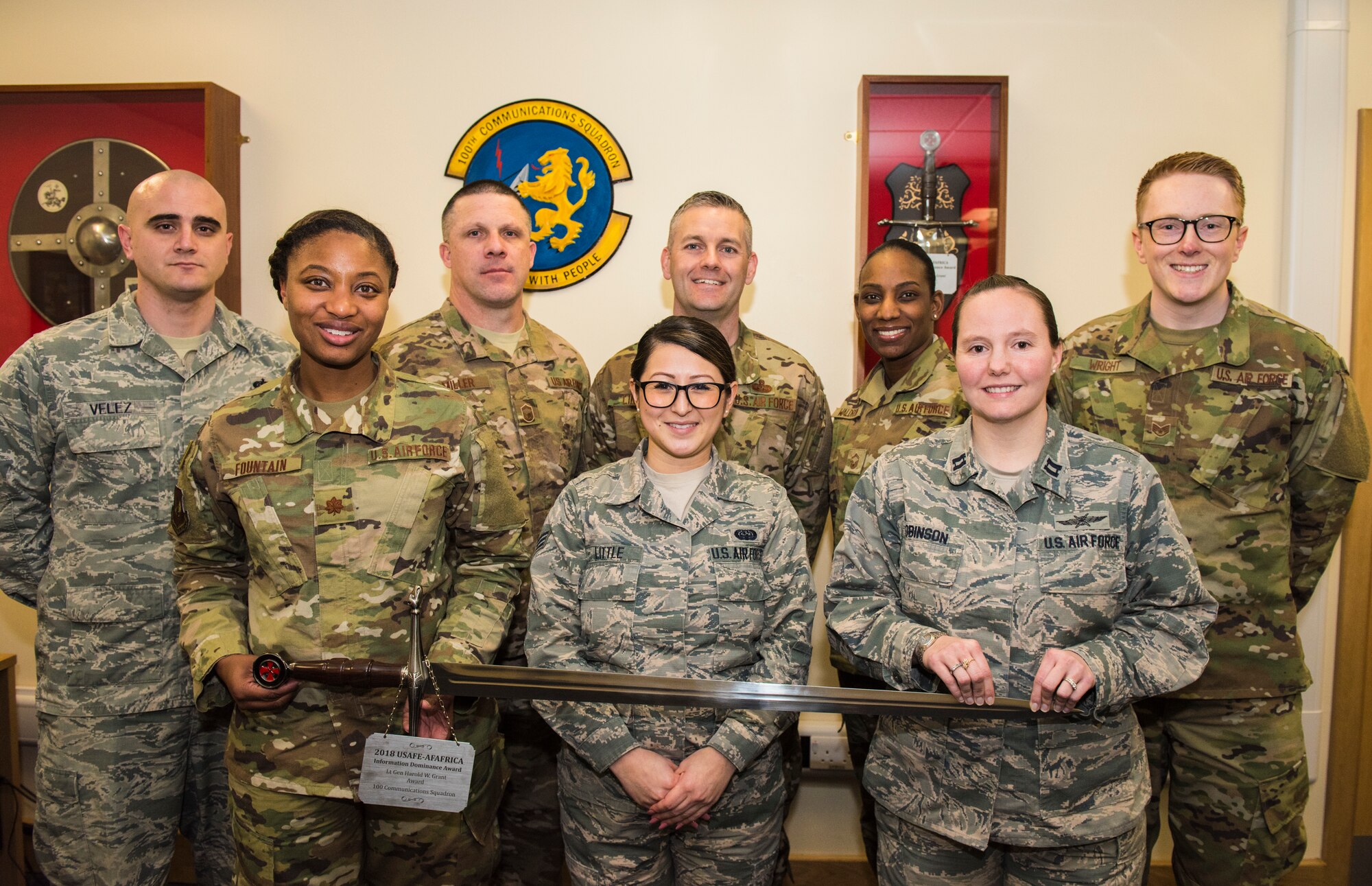 (First Row, From Left to Right) Maj. Erica Fountain (Commander), Senior Airman Aiko Little, Capt. Melissa Robinson, (Back Row, From Left to Right) Tech. Sgt. Ian Velez, Senior Master Sgt. Michael Miller, Chief Master Sgt. Jeremy Lindner, Senior Master Sgt. Lanora Waldron, and Staff Sgt. Matthew Wright, 100th Communications Squadron, pose with the Lt. Gen Harold W. Grant Award at RAF Mildenhall, Jan. 29, 2019. The Airmen were the squadron’s top performers for 2018. (U.S. Air Force Photo by Senior Airmen Kelly O’Connor)