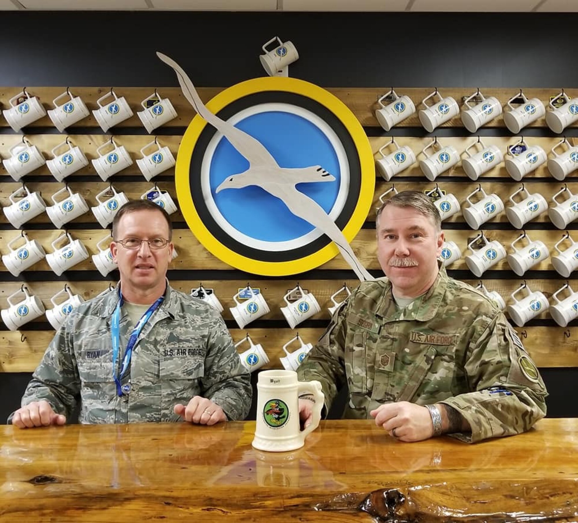 Master Sgts. Pat Ryan and Robert Segrin pose with Captain Paul L. Utz’s stein, which was found after five decades during a building renovation project. Both Airmen were instrumental in the return of the stein to Utz’s family.