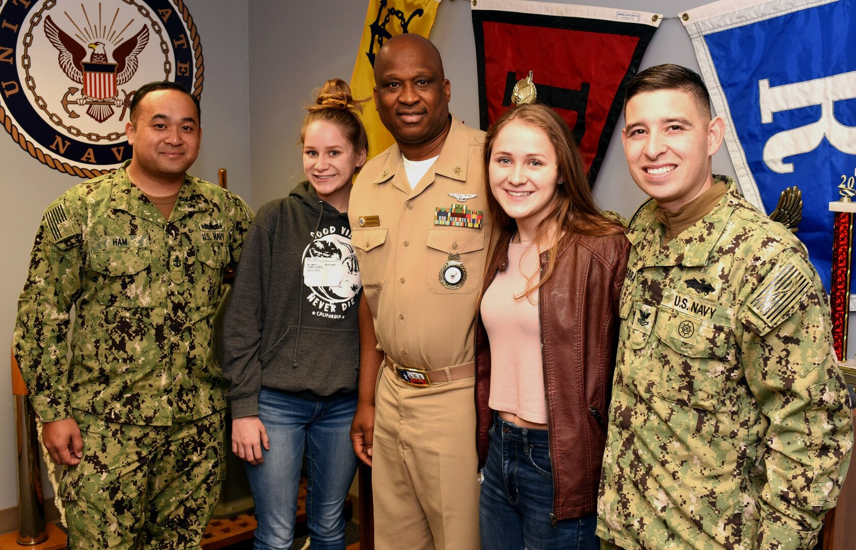 (From left) Chief Petty Officer Sambath Ham, Navy Recruiting Station North East; future Sailor Halle Von Plueren; Master Chief Petty Officer Matthew Maduemesi, chief recruiter of Navy Recruiting District San Antonio; future Sailor Hanna Von Plueren; and Petty Officer 2nd Class Francisco Sierra of NRS North East, pose for photos at NRD San Antonio headquarters at Joint Base San Antonio-Fort Sam Houston. Continuing a family tradition of military service, the Von Pluerens of San Antonio, who are fraternal twins, are joining America’s Navy.