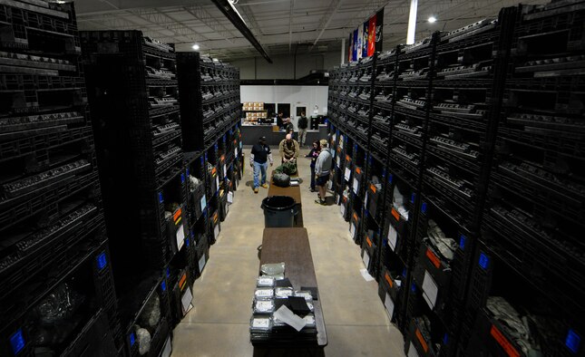 Airmen assigned to the 375th Logistics Readiness Squadron assist an Airman with gathering the needed items for a mobility exercise in the Individual Protective Equipment warehouse on Scott Air Force Base, Illinois, Jan. 23, 2019. During the MOBEX, the wing was tested on its ability to deploy nearly 250 Airmen. Part of this training requires Airmen to be issued gear they would need in a deployed location. The warehouse holds enough gear to outfit 5,760 Airmen at any given time.