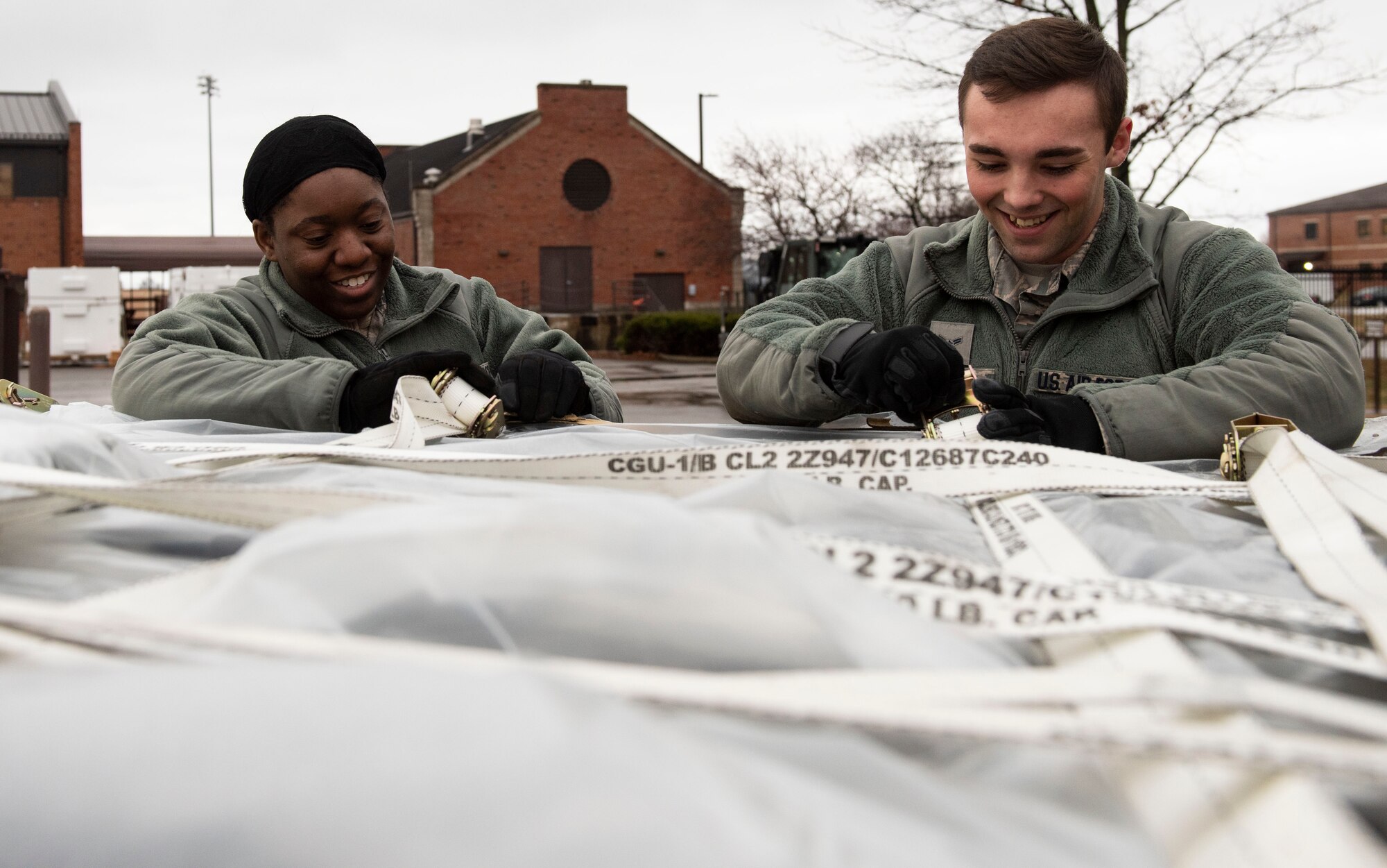 Senior Airman Dominique Lance and Airman 1st Class Brayden Bell , 375th Medical Support Squadron medical material technicians, adjust the cargo straps on a pallet of medical supplies during a mobility exercise, Jan. 23, 2019, at Scott Air Force Base, Illinois. This stage of the exercise requires close coordination between the 375th MDSS and the 375th Logistics Readiness Squadron, whose air and ground transportation crews ensure the cargo is properly palletized for safe loading onto aircraft.