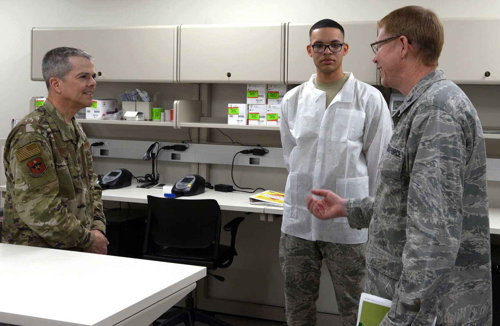 Maj. Gen. John J. DeGoes (left), 59th Medical Wing commander, speaks about the capabilities of the Gateway Bulverde Clinic with Col. Robert Bogart (right), 59th Medical Operations Group commander, and Senior Airman Noah Williams (center), 59th MDW laboratory technician Jan. 25. The Gateway Bulverde Clinic features comprehensive family health care with on-site laboratory and pharmacy services.