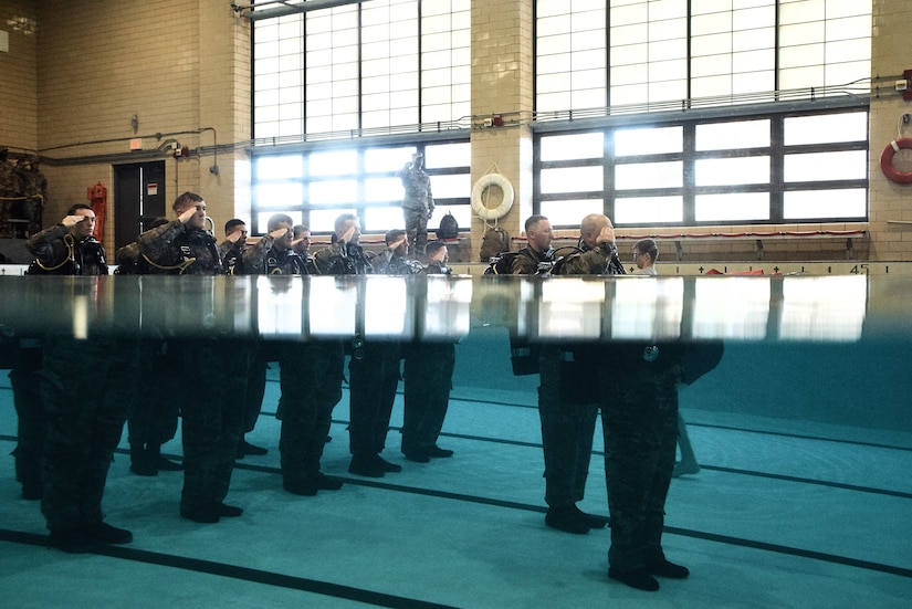 U.S. Army Soldiers from the 74th Engineer Dive Detachment, 92nd Eng. Battalion, salute during a change of command ceremony at the Anderson Field House pool at Joint Base Langley-Eustis, Virginia, Jan. 25, 2019.