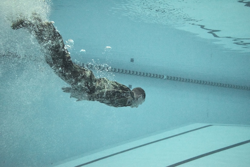 U.S. Army Capt. Maxwell McDonnell, 74th Engineer Dive Detachment, 92nd Eng. Battalion incoming commander, swims toward the formation during a change of command ceremony at the Anderson Fieldhouse pool at Joint Base Langley-Eustis, Virginia, Jan. 25, 2019.