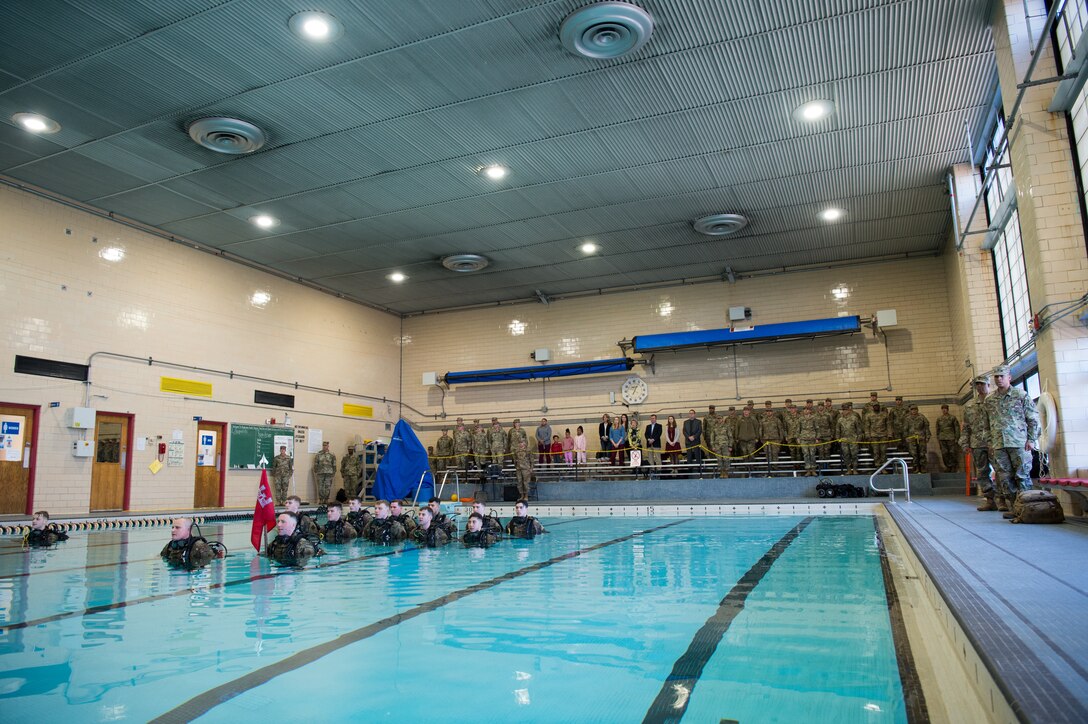 U.S. Army Soldiers and civilians from the 92nd Engineer Battalion sing the Army song during a change of command ceremony at the Anderson Fieldhouse pool at Joint Base Langley-Eustis, Virginia, Jan. 25, 2019.