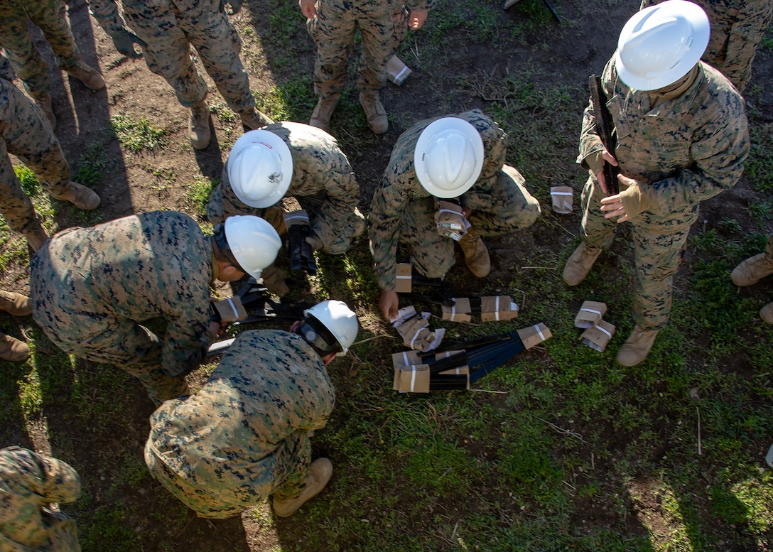 U.S. Marines with Marine Wing Support Squadron (MWSS) 373, Marine Wing Support Group (MWSG) 37, 3rd Marine Aircraft Wing (MAW), gather stakes  to build the foundation for the air strip during the Catalina Island Airport in the Sky project at Catalina Island, Calif., Jan. 21. The Catalina Island Airport in the Sky project is a strategic training opportunity and allows a rare collaboration that benefits both the Marine Corps and the Catalina Island Conservancy. (U.S. Marine Corps photo by Lance Cpl. Juan Anaya)