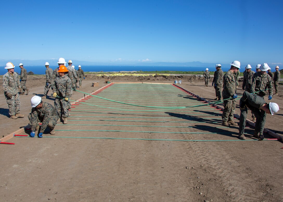 U.S. Marines with Marine Wing Support Squadron (MWSS) 373, Marine Wing Support Group (MWSG) 37, 3rd Marine Aircraft Wing, stage metal rods at the air strip construction site during the Catalina Island Airport in the Sky project at Catalina Island, Calif., Jan. 21. The partnership between the Marine Corps and the Catalina Island Conservancy provides a unique opportunity to conduct applicable training while also helping the community. (U.S. Marine Corps photo by Lance Cpl. Juan Anaya)