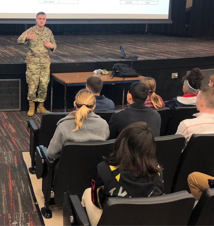 Male Soldier speaking in front of classroom to students.