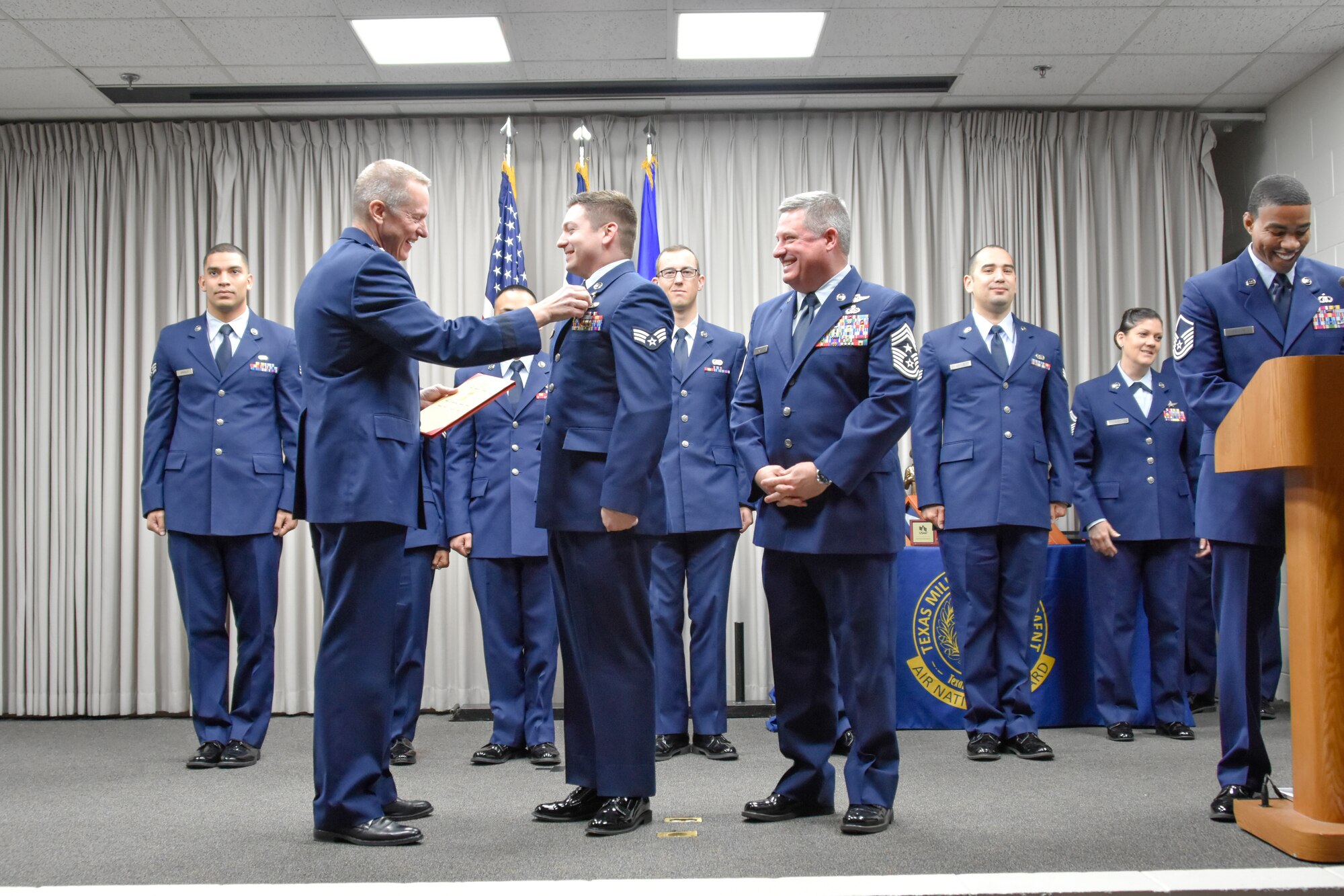 Maj. Gen. David McMinn, commander of the Texas Air National Guard, and Chief Master Sgt. Christopher Castle, command chief of the TANG, pin the Texas Medal of Merit on Senior Airman Kristopher Benfer, the 136th Airlift Wing Airman of the Year and Texas Air National Guard Outstanding Airman of the Year recipient, January 13, 2019 at Camp Mabry in Austin, Texas. Benfer will move forward to compete at the national level for the entire Air National Guard. (U.S. Air National Guard photo by Tech. Sgt. Katy Whitt)