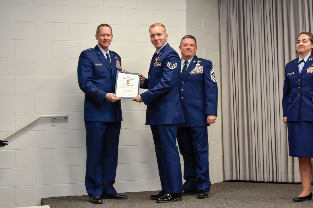 Staff Sgt. Sean Kornegay, 136th Airlift Wing Public Affairs broadcast journalist, receives a coin and certificate from Maj. Gen. David McMinn, commander of the Texas Air National Guard, and Chief Master Sgt. Christopher Castle, command chief of the TANG, during the Outstanding Airman of the Year award ceremony January 13, 2019 at Camp Mabry in Austin, Texas. Kornegay was one of five Airmen chosen to compete from the 136th Airlift Wing. (U.S. Air National Guard photo by Tech. Sgt. Katy Whitt)