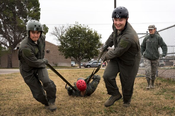 2nd Lt. Eric Wiggins and other student pilots from Specialized Undergraduate Pilot Training class 20-05 practice their parachute landing falls, Jan. 17, 2019, at Laughlin Air Force Base, Texas. They used two and four foot platforms to jump from, and when they fell, they practiced making 5 points of contact during the roll. According to instructors, if they were to land feet-first from a parachute jump, they could potentially break their legs. (U.S. Air Force photo by Airman 1st Class Anne McCready)
