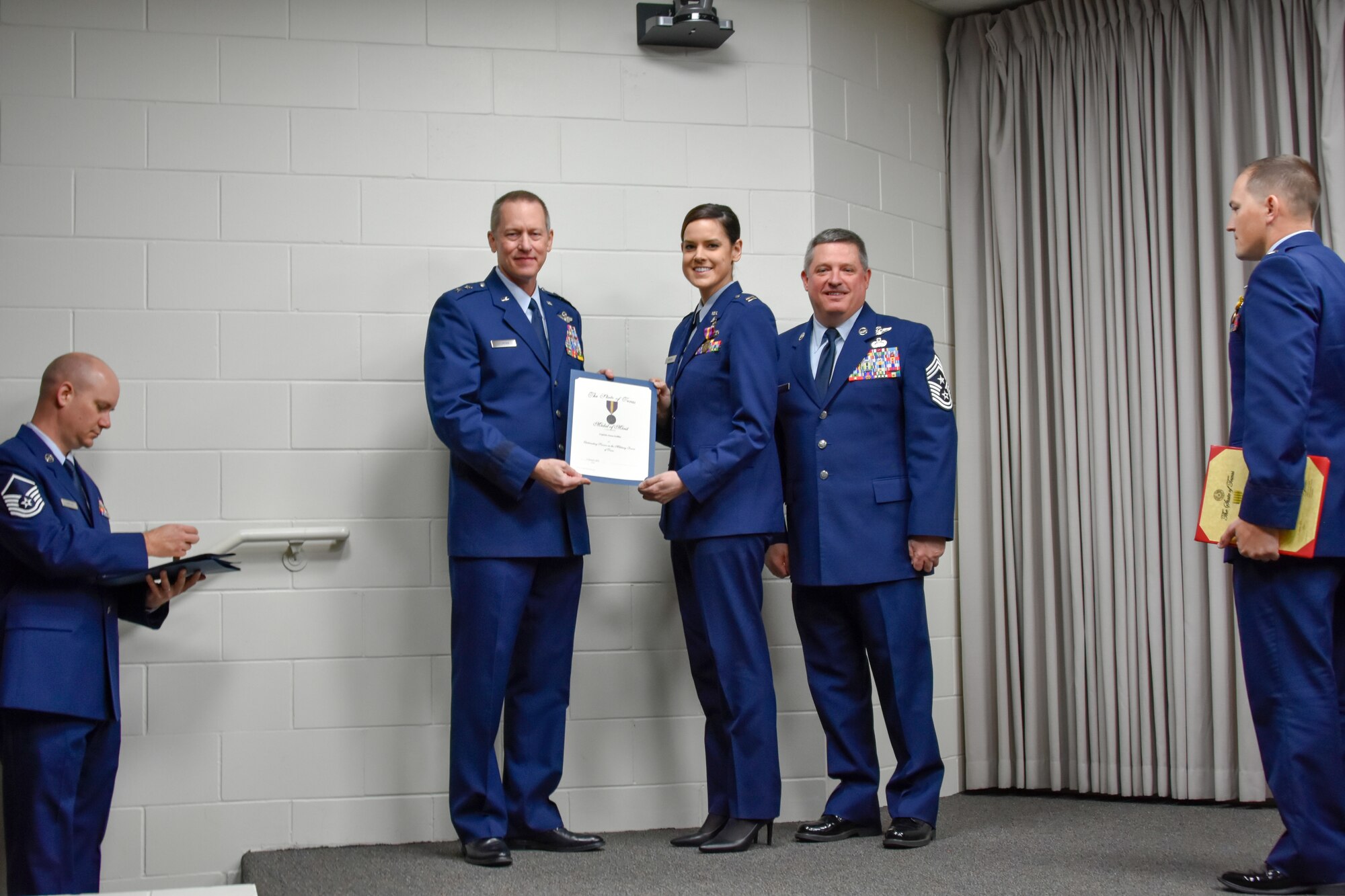 Capt. Anna Griffin, 136th Maintenance Squadron aircraft maintenance officer, receives a certificate from Maj. Gen. David McMinn, commander of the Texas Air National Guard, and Chief Master Sgt. Christopher Castle, command chief of the TANG, during the Outstanding Airman of the Year award ceremony January 13, 2019 at Camp Mabry in Austin, Texas. The Airman of the Year award recognizes outstanding Guardsmen for superior leadership, job performance, community involvement, and personal achievements. (U.S. Air National Guard photo by Tech. Sgt. Katy Whitt)