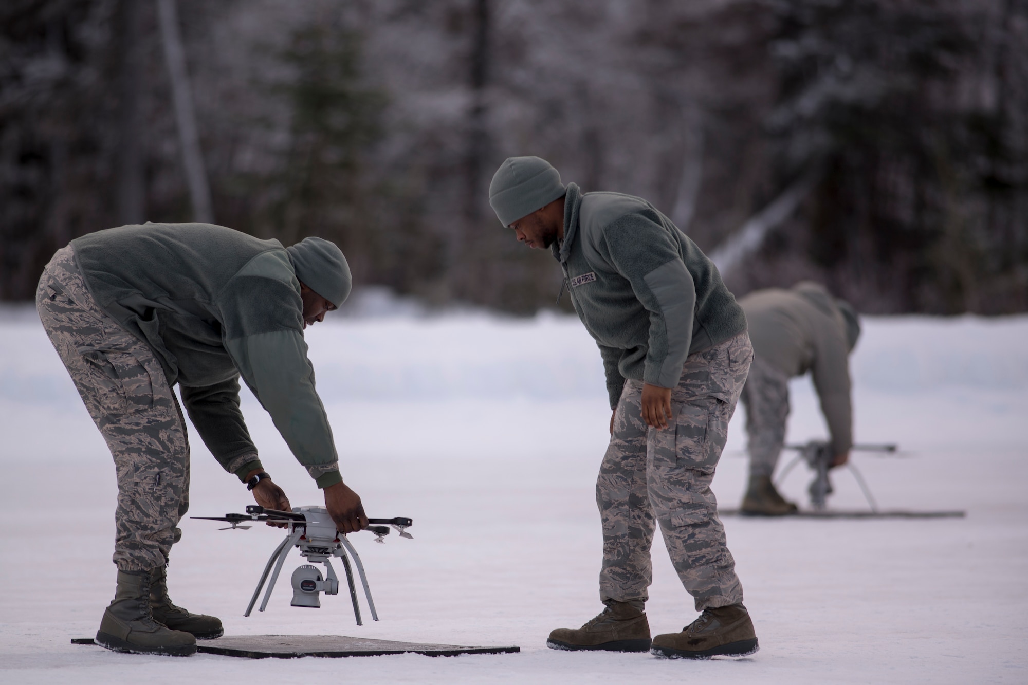 U.S. Air Force Staff Sgt. Jason Holmes, 51st Civil Engineer Squadron engineer apprentice stationed at Osan Air Base, South Korea, and Airman 1st Class Shane Leaphart, a 773d CES engineer apprentice, conduct a preflight inspection on a Small Unmanned Aircraft System during a newly adopted Rapid Airfield Damage Assessment System training course at Joint Base Elmendorf-Richardson, Alaska, Jan. 23, 2019. Throughout the first week of training Airmen focused on learning to fly the SUAS. During the second week they learned to fly the RADAS mission while using the new system.