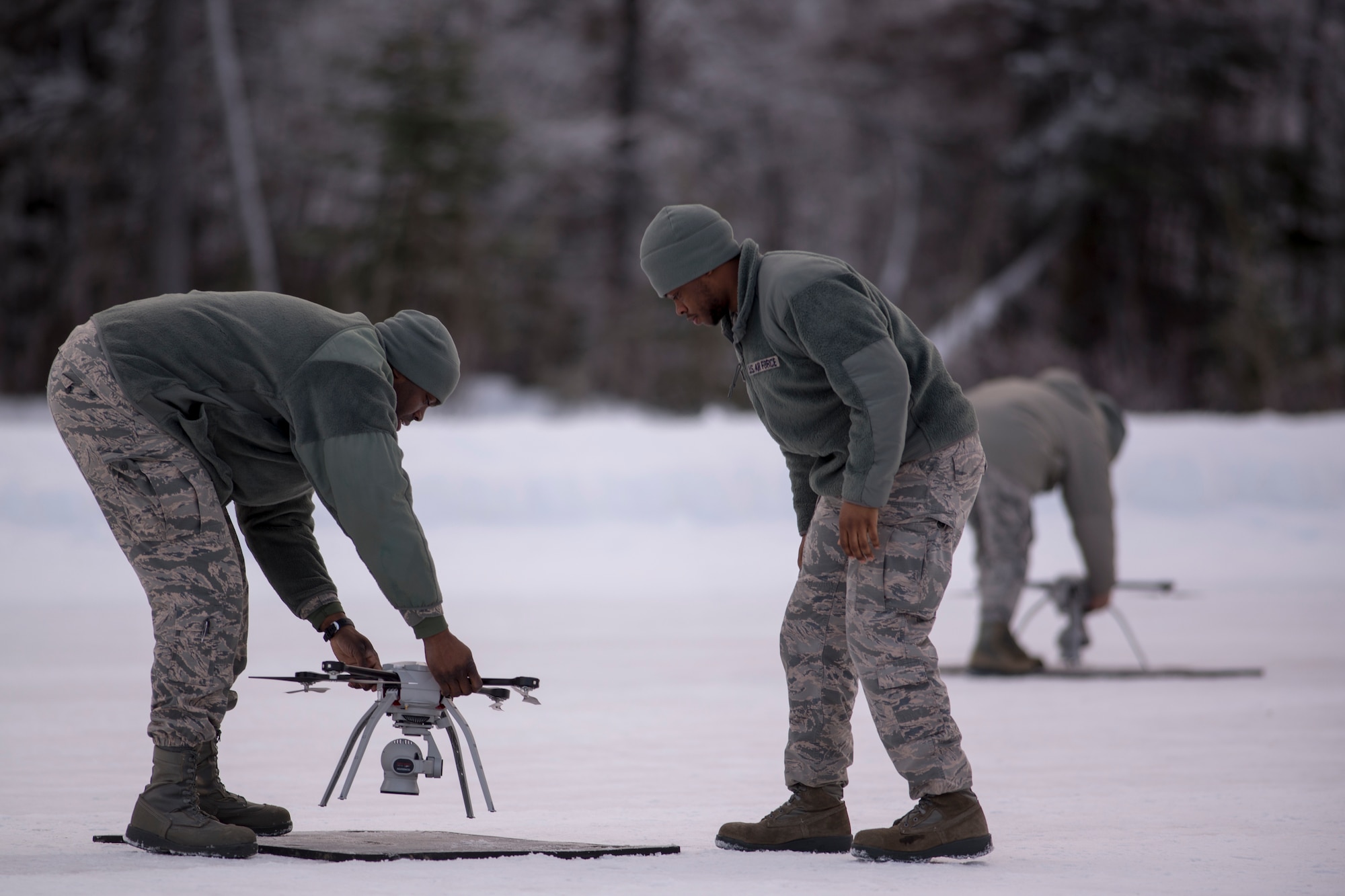 U.S. Air Force Staff Sgt. Jason Holmes, 51st Civil Engineer Squadron engineer apprentice stationed at Osan Air Base, South Korea, and Airman 1st Class Shane Leaphart, a 773d CES engineer apprentice, conduct a preflight inspection on a Small Unmanned Aircraft System during a newly adopted Rapid Airfield Damage Assessment System training course at Joint Base Elmendorf-Richardson, Alaska, Jan. 23, 2019. Throughout the first week of training Airmen focused on learning to fly the SUAS. During the second week they learned to fly the RADAS mission while using the new system.