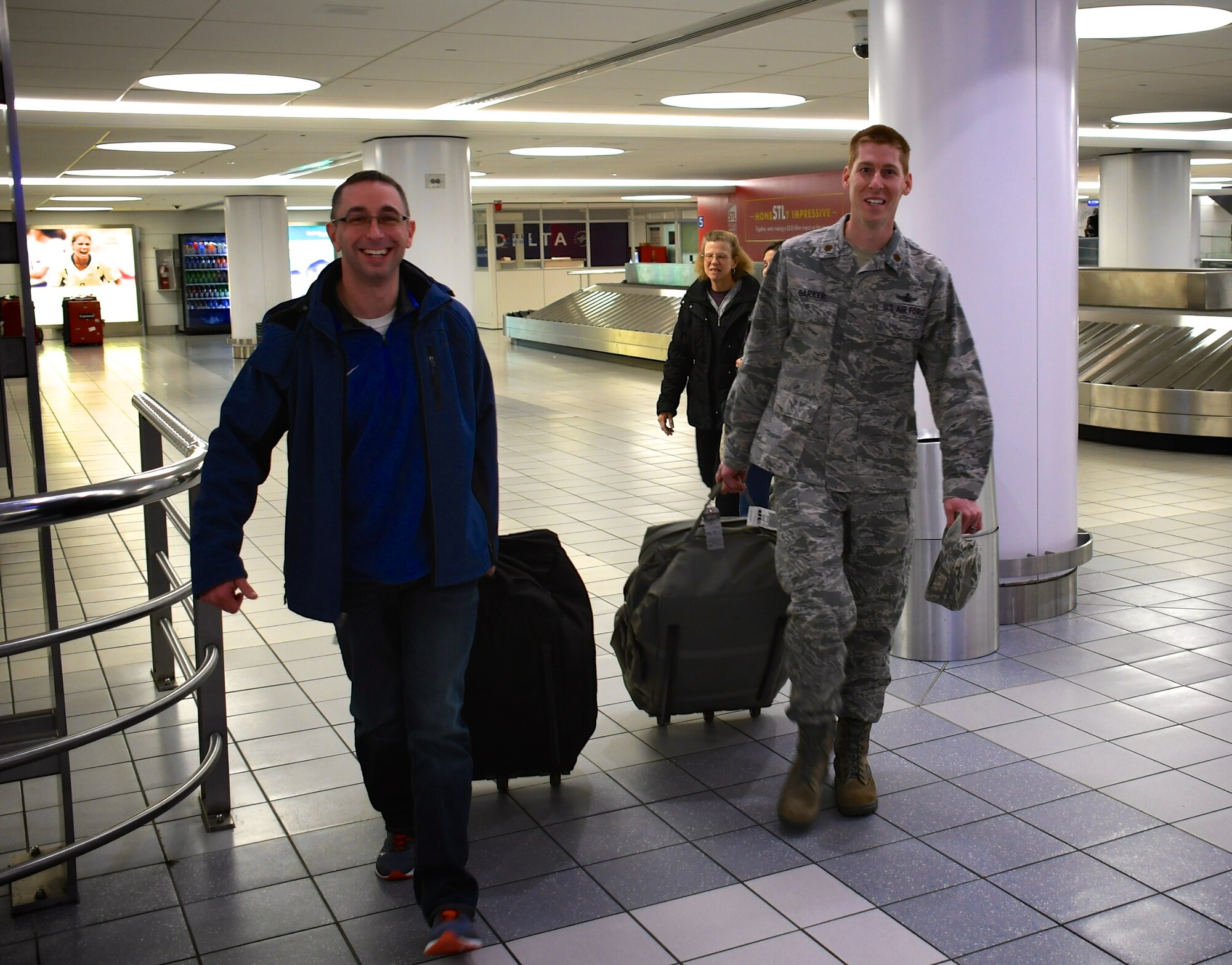 932nd Airlift Wing staff members welcomed back several Airmen from temporary duties recently, including deployer Chaplain (Maj.) Michael Williams, at left. Shaking hands then helping carry his luggage upon arrival back in Illinois on January 29, 2019, is Maj. Luke Barker, the 932nd AW Director of Staff. The 932nd Airlift Wing is a 22nd Air Force unit, under Air Force Reserve Command.  The "Gateway Wing" unit is located at Scott Air Force Base, Illinois, not far from Saint Louis. (U.S. Air Force photo by Lt. Col Stan Paregien)