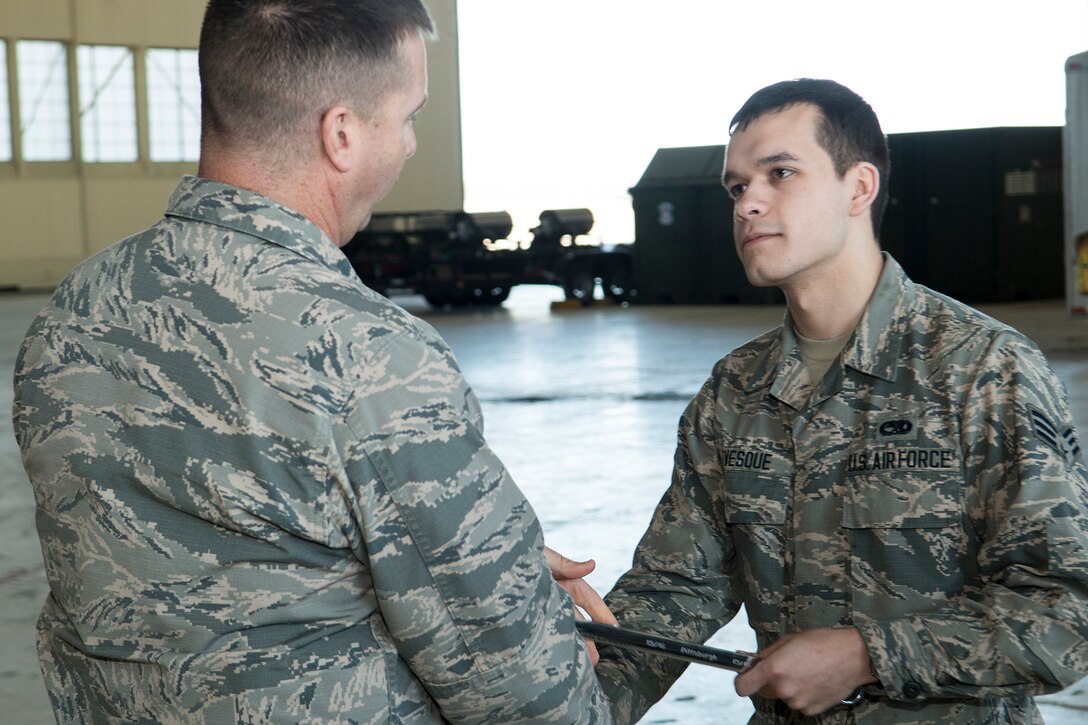 U.S. Air Force Reserve Col. Casey Cooley, 307th Maintenance Group commander, presents the “Knuckle Buster” award to Senior Airman Tyler Levesque on Jan. 25, 2019, Barksdale Air Force Base, Louisiana. Levesque is assigned to the 2nd Maintenance Squadron and received the award for discovering that two control cables (the Lateral Control cable and the Drag Chute cable) on a B-52H Stratofortress were improperly routed. His perserverance in ensuring the cables were correctly configured displayed his professionalism and dedication. Levesque serves with the 307th MXS as part of the Total Force Enterprise concept.  (U.S. Air Force photo by Greg Steele)