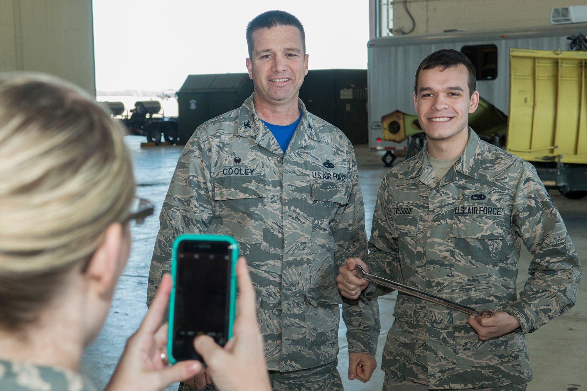 U.S. Air Force Senior Airman Tyler Levesque poses for a picture with Col. Casey Cooley, 307th Maintenance Group commander, after receiving the “Knuckle Buster” award on Jan. 25, 2019, Barksdale Air Force Base, Louisiana. Levesque is assigned to the 2nd Maintenance Squadron and received the award for discovering that two control cables (the Lateral Control cable and the Drag Chute cable) on a B-52H Stratofortress were improperly routed. (U.S. Air Force photo by Greg Steele)