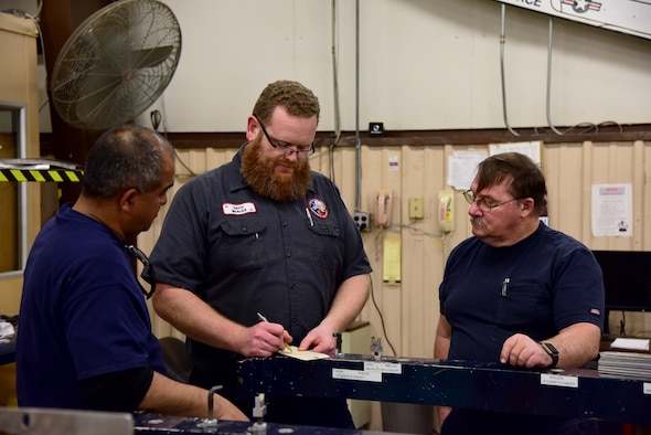 David Mercer, a 47th Maintenance Directorate fabrication work lead, discusses shift assignments with his maintenance personnel staff at Laughlin Air Force Base, Texas, Jan. 28, 2019. Mercer was selected for the “XLer of the Week” for his help in overcoming structural maintenance obstacles, saving taxpayer dollars and training the next generation of maintenance professionals. (U.S. Air Force photo by Senior Airman John A. Crawford)