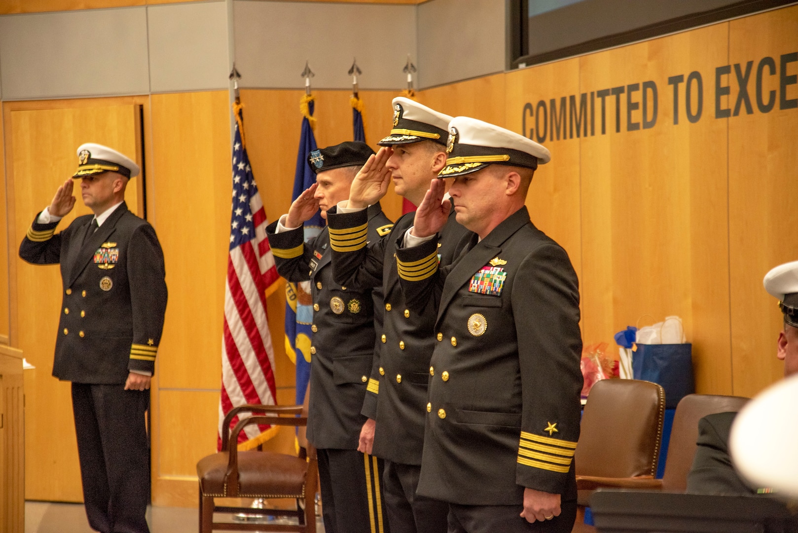 Defense Intelligence Agency Director Lt. Gen. Robert P. Ashley,. Jr., second from left, outgoing Defense Intelligence Agency Navy Element Commander Capt. Joshua C. Himes, second from right, and incoming Navy Element commander, Capt. Peter N. Shepard, right, salute during a change of command ceremony, Jan. 30, at the DIA headquarters on Joint Base Anacostia-Bolling.