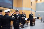 Capt. Joshua C. Himes, right, relinquishes command of the Defense Intelligence Agency Navy Element to Capt. Peter N. Shepard, left, during a change of command ceremony, Jan. 30, at the DIA headquarters on Joint Base Anacostia-Bolling.