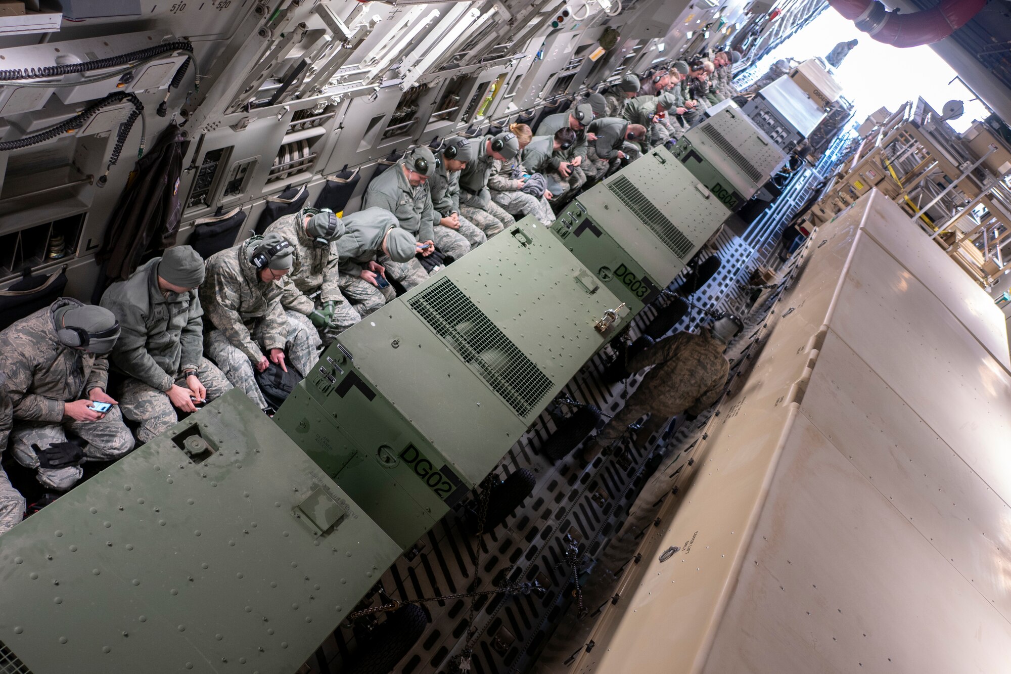Members and cargo from the 119th Wing are loaded onto a Hawaii Air National Guard C-17 Globemaster III