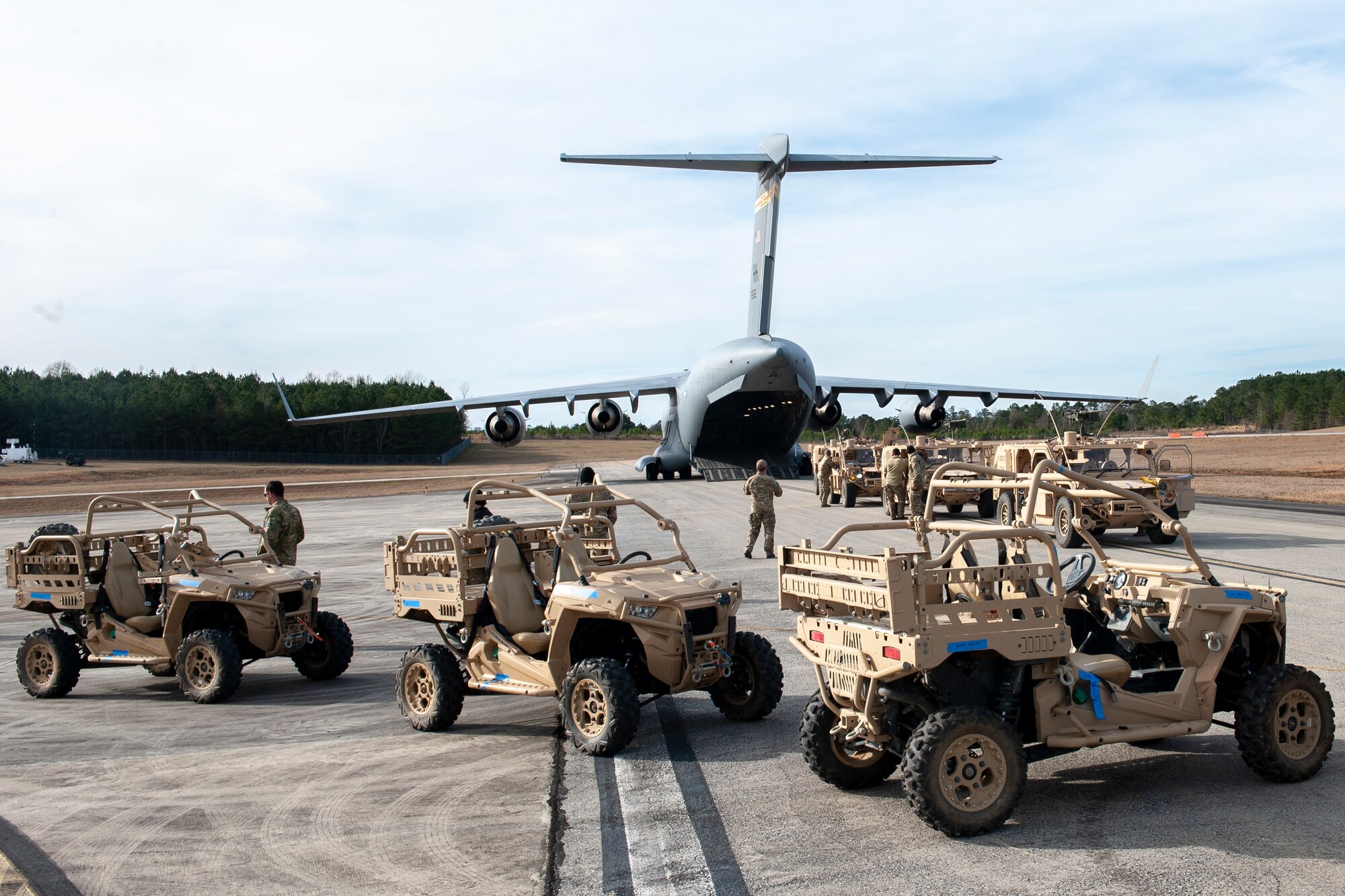 U.S. Army Soldiers and vehicles from the 3rd Special Forces Group prepare to board a Hawaii Air National Guard C-17 Globemaster III