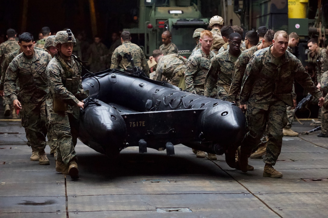 Marines with Alpha Company, Battalion Landing Team, 1st Battalion, 4th Marines,, carry a Combat Rubber Raiding Craft during a time trial and competition aboard the dock landing ship USS Ashland (LSD 48), Philippine Sea, Jan. 21, 2019. Alpha Company Marines specialize in ship-to-shore small-boat raids as part of BLT 1/4, the Ground Combat Element for the 31st Marine Expeditionary Unit. The 31st MEU, the Marine Corps’ only continuously forward-deployed MEU partnering with the Wasp ARG, provides a flexible and lethal force ready to perform a wide range of military operations as the premier crisis response force in the Indo-Pacific region. (Official Marine Corps photo by Lance Cpl. Harrison C. Rakhshani/Released)