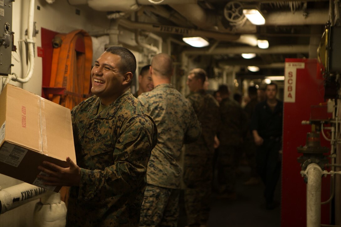 Marines with the 31st Marine Expeditionary Unit and Sailors with the amphibious assault ship USS Wasp (LHD 1) carry supplies through the ship during replenishment at sea, Jan. 20, 2019. During the RAS, the Marines and Sailors unloaded, sorted and stored 107 pallets of frozen foods, dry stores, and fresh fruits and vegetables. The 31st MEU, the Marine Corps’ only continuously forward-deployed MEU partnering with the Wasp ARG, provides a flexible and lethal force ready to perform a wide range of military operations as the premier crisis response force in the Indo-Pacific region. (Official Marine Corps video by Cpl. Luis Velez/ Released)
