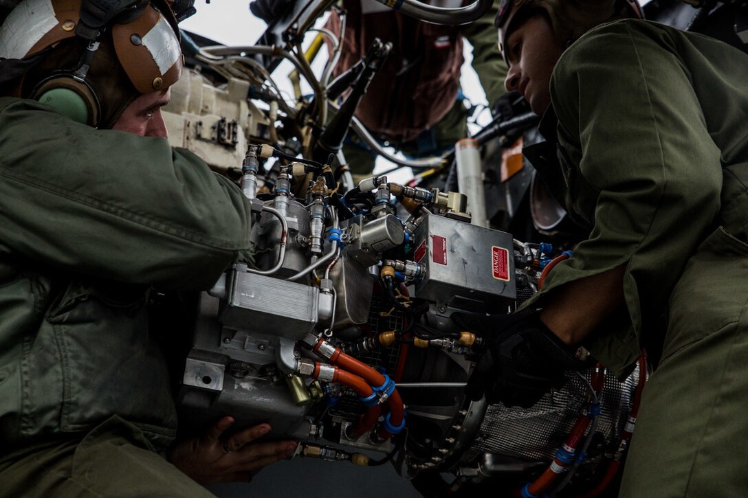Marines with Marine Medium Tiltrotor Squadron 262 (Reinforced) install an auxiliary power unit onto an MV-22B Osprey tiltrotor aircraft atop the flight deck aboard the amphibious assault ship USS Wasp (LHD 1), Philippine Sea, Jan. 27, 2019. VMM-262 (Rein.) is the Aviation Combat Element for the 31st Marine Expeditionary Unit. VMM-262 (Rein.) maintainers ensure the squadron’s aircraft are safe for flight during flight operations. The 31st MEU, the Marine Corps’ only continuously forward-deployed MEU partnering with the Wasp Amphibious Ready Group, provides a flexible and lethal force ready to perform a wide range of military operations as the premier crisis response force in the Indo-Pacific region. (U.S. Marine Corps photo by Lance Cpl. Kyle P. Bunyi/ Released)