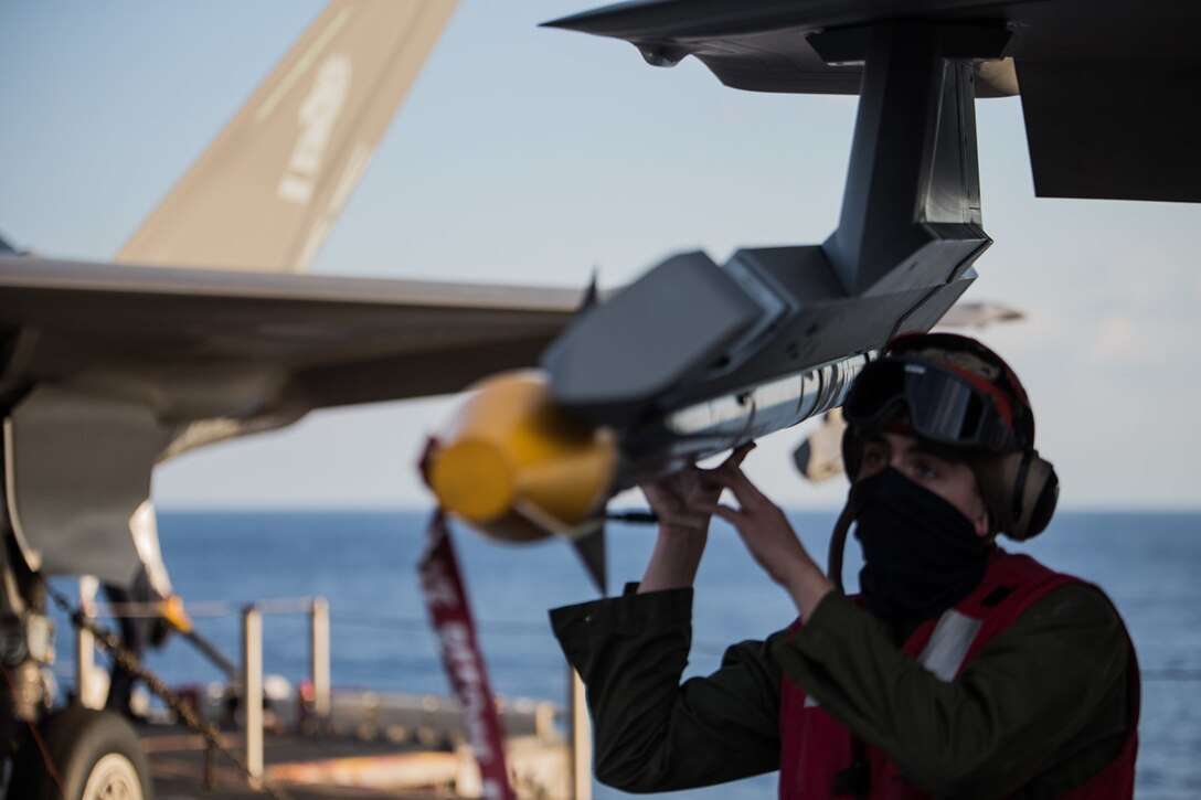 Lance Cpl. Shawn M. Spurlock, an ordnance technician with the F-35B Lightning II detachment of Medium Marine Tiltrotor Squadron 262 (Reinforced), secures a Captive Air Training Missile -9X Sidewinder to an F-35B fighter atop the flight deck aboard the amphibious assault ship USS Wasp (LHD 1), Philippine Sea, Jan. 28, 2019. Spurlock, a native of New Freedom, Pennsylvania, graduated from Susquehannock High School in June 2017 before enlisting later that month. Naval aviators with the detachment fly the Marine Corps' newest, most advanced multi-role fighter, the F-35B. The 31st Marine Expeditionary Unit, the Marine Corps’ only continuously forward-deployed MEU partnering with the Wasp Amphibious Ready Group, provides a flexible and lethal force ready to perform a wide range of military operations as the premier crisis response force in the Indo-Pacific region. (U.S. Marine Corps photo by Lance Cpl. Kyle P. Bunyi/ Released)