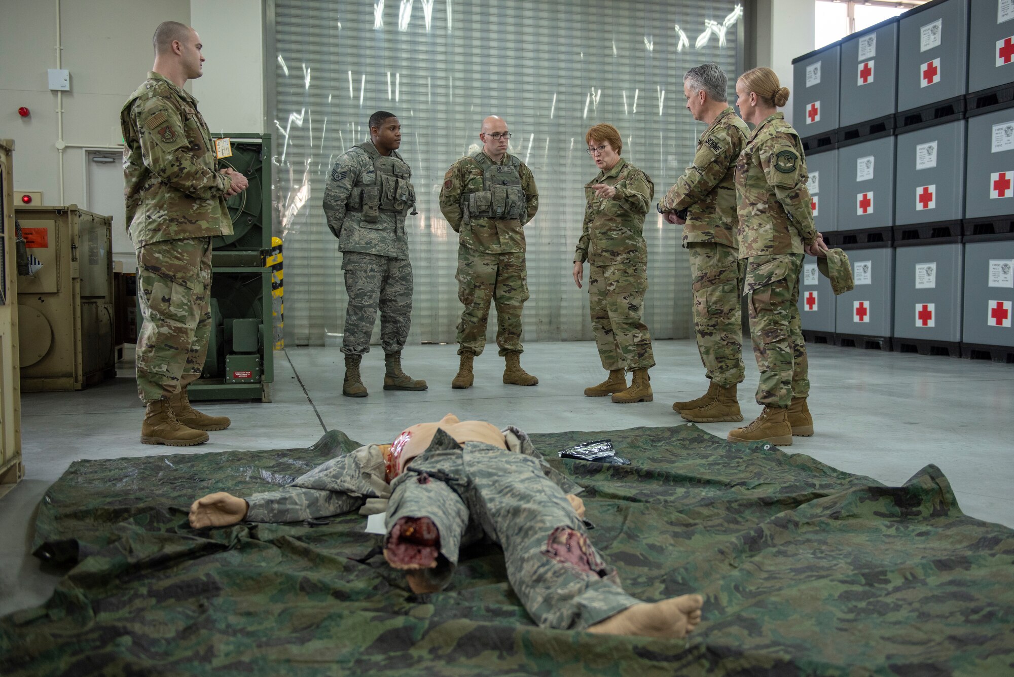 Lt. Gen. Dorothy Hogg, 23rd U.S. Air Force Surgeon General, discusses Tactical Casualty Combat Care (TCCC) training with a pair of 374th Security Forces Squadron defenders after a TCCC demonstration at Yokota Air Base, Japan, Jan. 29, 2019.