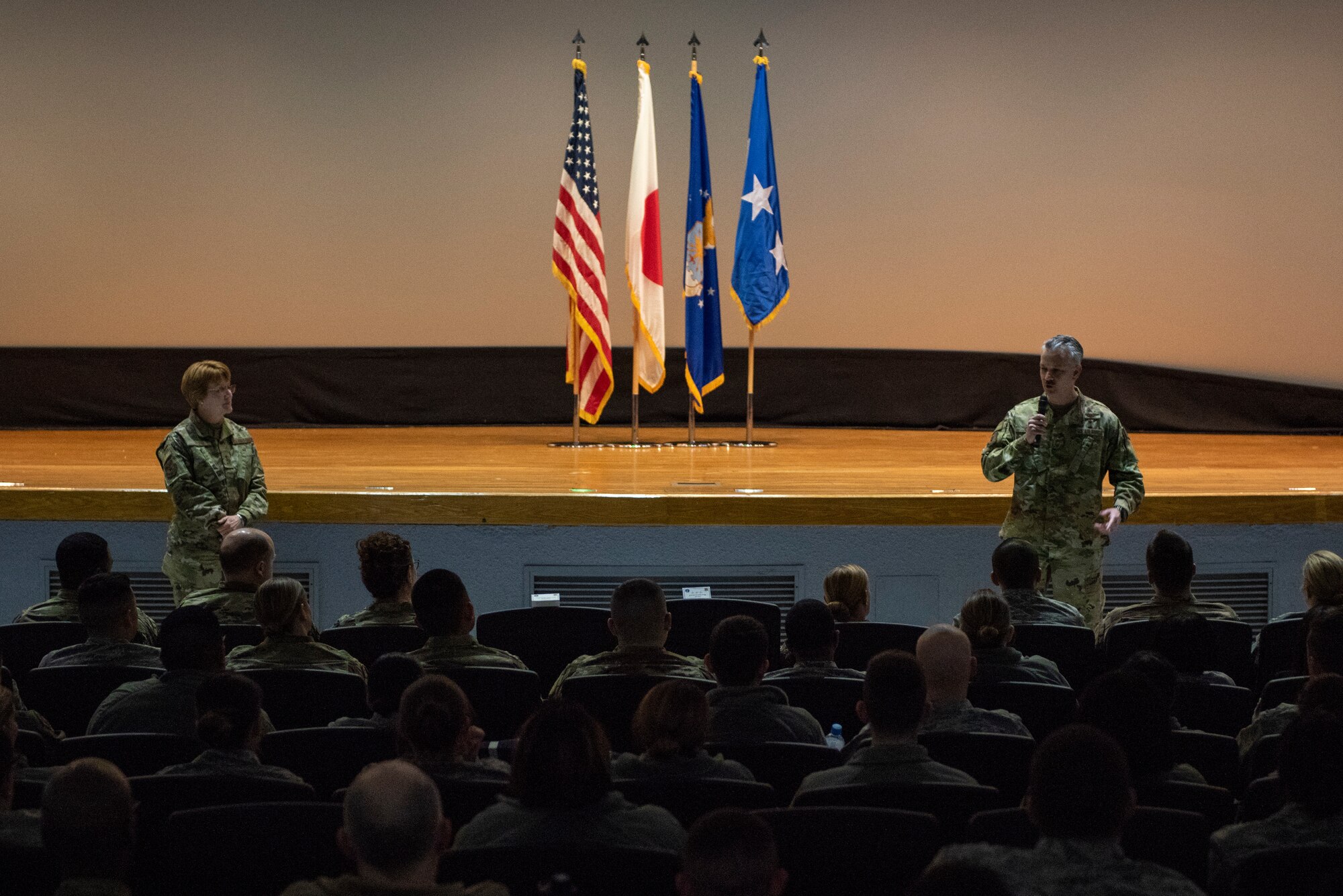 Lt. Gen. Dorothy Hogg, 23rd U.S. Air Force Surgeon General, left, and Chief Master Sgt. G. Steve Cum, Chief of the Medical Enlisted Force, right, speak with the Airmen of the 374th Medical Group during an all call at Yokota Air Base, Japan, Jan. 29, 2019.