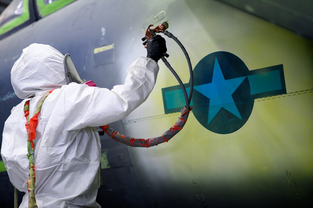 An Airman assigned to the 48th Equipment Maintenance Squadron Corrosion Control Section, paints around a National Star insignia on an F-15E Strike Eagle during a heritage paint job at Royal Air Force Lakenheath, England, Jan. 18, 2019. More than 640 man-hours, across 15 days and $15,000 worth of painting equipment went into the process. (U.S. Air Force photo by Senior Airman Malcolm Mayfield)
