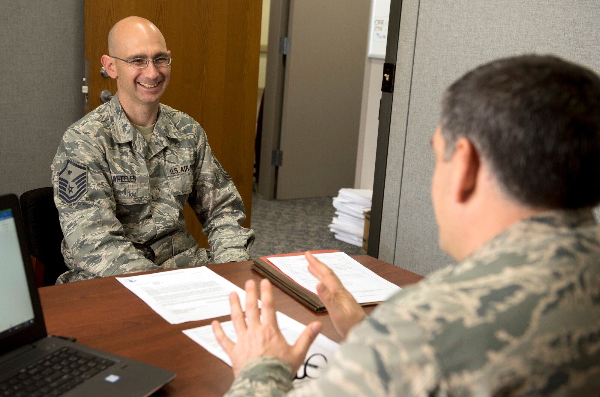 A first sergeant with a wing member during an office visit.