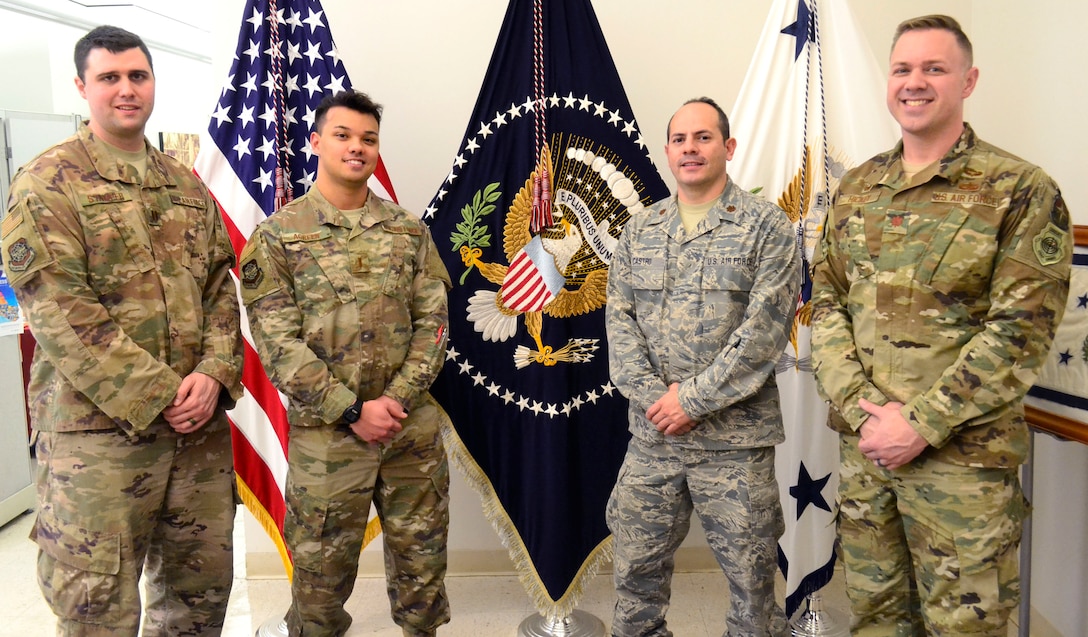 Visitors from the Logistics Officer Association’s Pudgy Chapter from Joint Base McGuire-Dix-Lakehurst pose in front of a display in DLA Troop Support’s flag room during a tour Jan. 24, 2019 in Philadelphia.