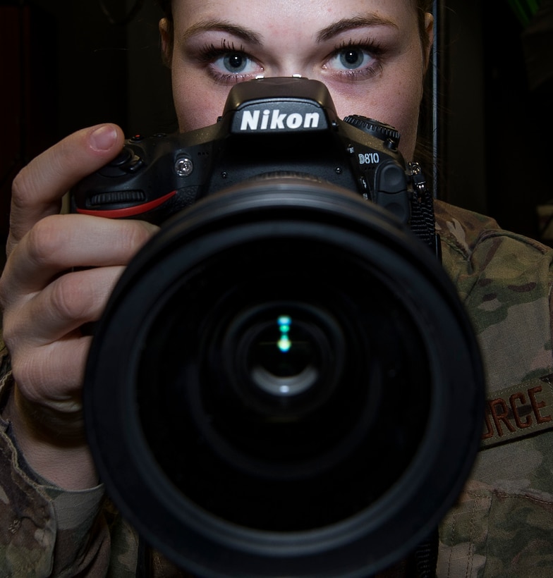 U.S. Air Force Senior Airman BrieAnna Stillman, 20th Fighter Wing photojournalist, posses for a picture with her equipment at Shaw Air Force Base, S.C., Jan. 25, 2019.