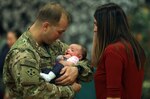 Capt. Harold Rivard, assigned to 2nd Battalion, 12th Infantry Regiment, 2nd Infantry Brigade Combat Team, 4th Infantry Division, is reunited with his daughter, Landry, and wife, Sarah, following a homecoming ceremony at the William Bill Reed Special Event Center, Fort Carson, Colo., Nov. 17, 2018.