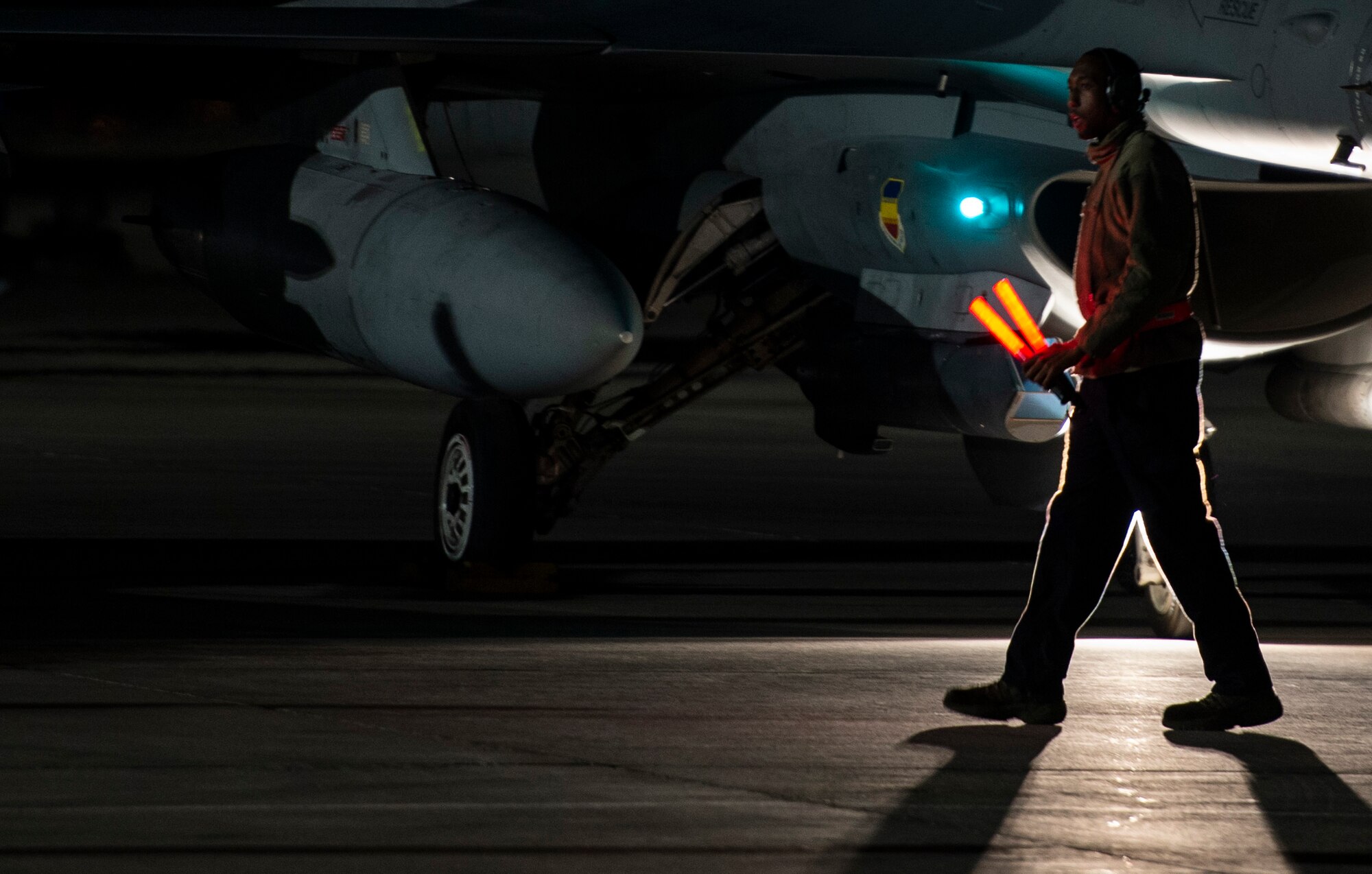 A U.S. Airman assigned to the 20th Aircraft Maintenance Squadron, 79th Aircraft Maintenance Unit, prepares to marshal an F-16CM Fighting Falcon during Exercise Red Flag 19-1 at Nellis Air Force Base, Nev., Jan. 30, 2019.