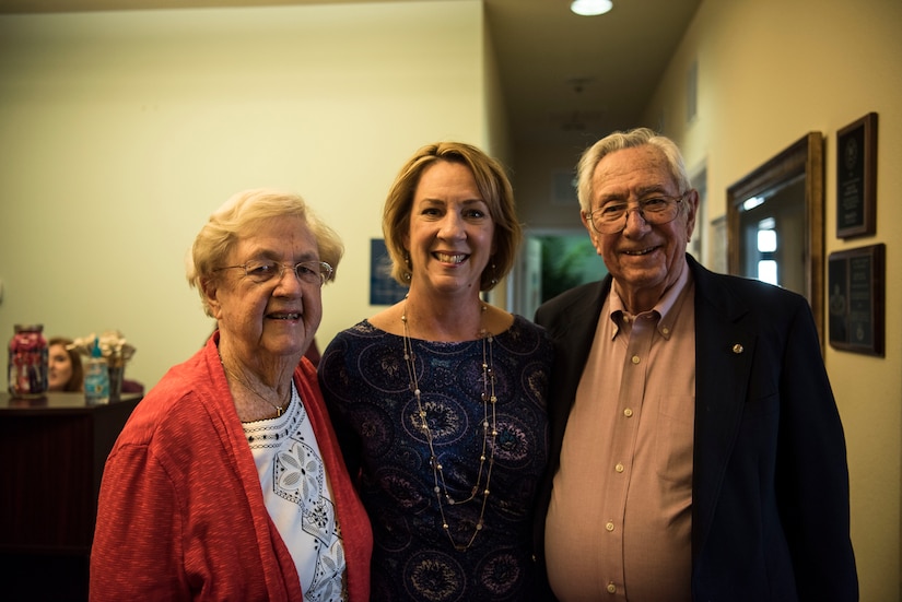 Kathy Edenborough, center, 628th Contracting Squadron director of business operations and 628th Air Base Wing small business specialist, stands with her parents at her retirement ceremony Jan. 30, 2019, at the Hunt Community Center on Joint Base Charleston, S.C.