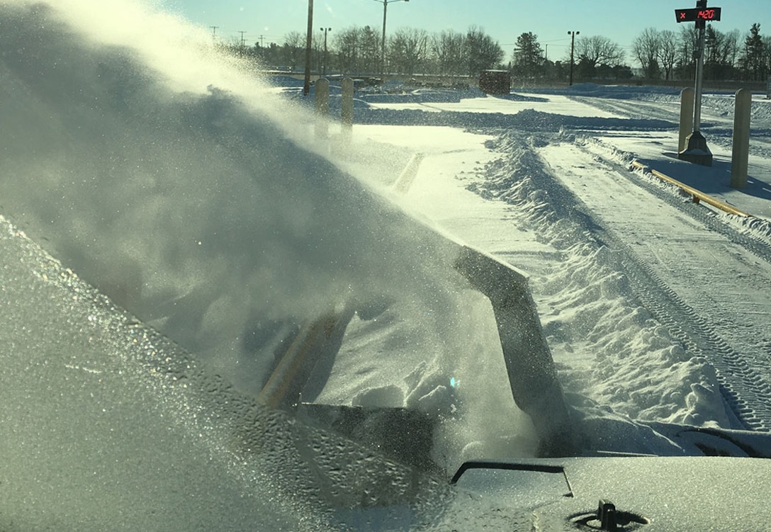 It may be sunny, but it's still minus 25 degrees as Disposal Service Representative Rob De Long uses a Bobcat with a snow blower to clear snow from the truck scale.
