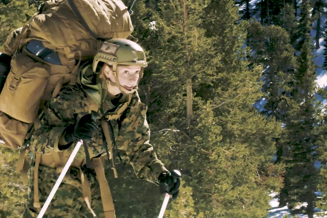 Baker skis across a mountain.