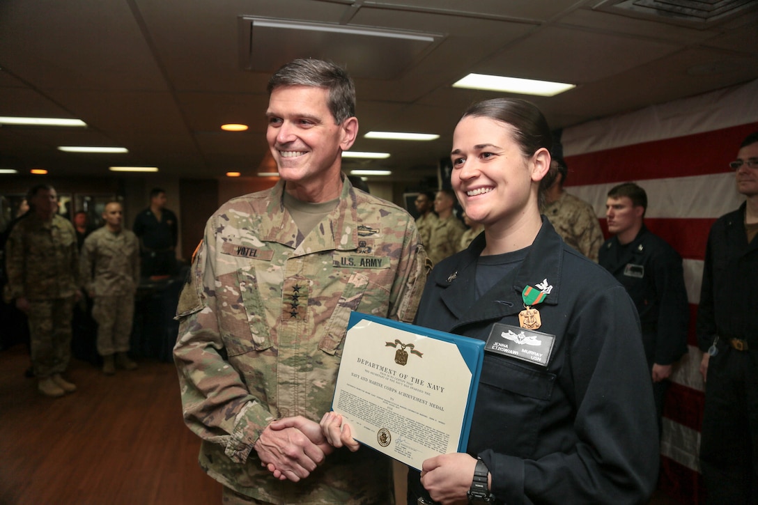 U.S. Army Gen. Joseph Votel, commander, U.S. Central Command, presents an award to Electronics Technician Second Class Jenna Murray, for serving as work center supervisor aboard the USS Kearsarge ( LHD3). Kearsarge is deployed to the U.S. 5th Fleet area of operations in support of naval operations to ensure maritime stability and security in the Central Region, connecting the Mediterranean and the Pacific through the western Indian Ocean and three strategic choke points. (U.S. Army photo by SGT Franklin Moore)